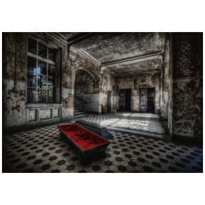 een lege kamer met een rode bank in het midden