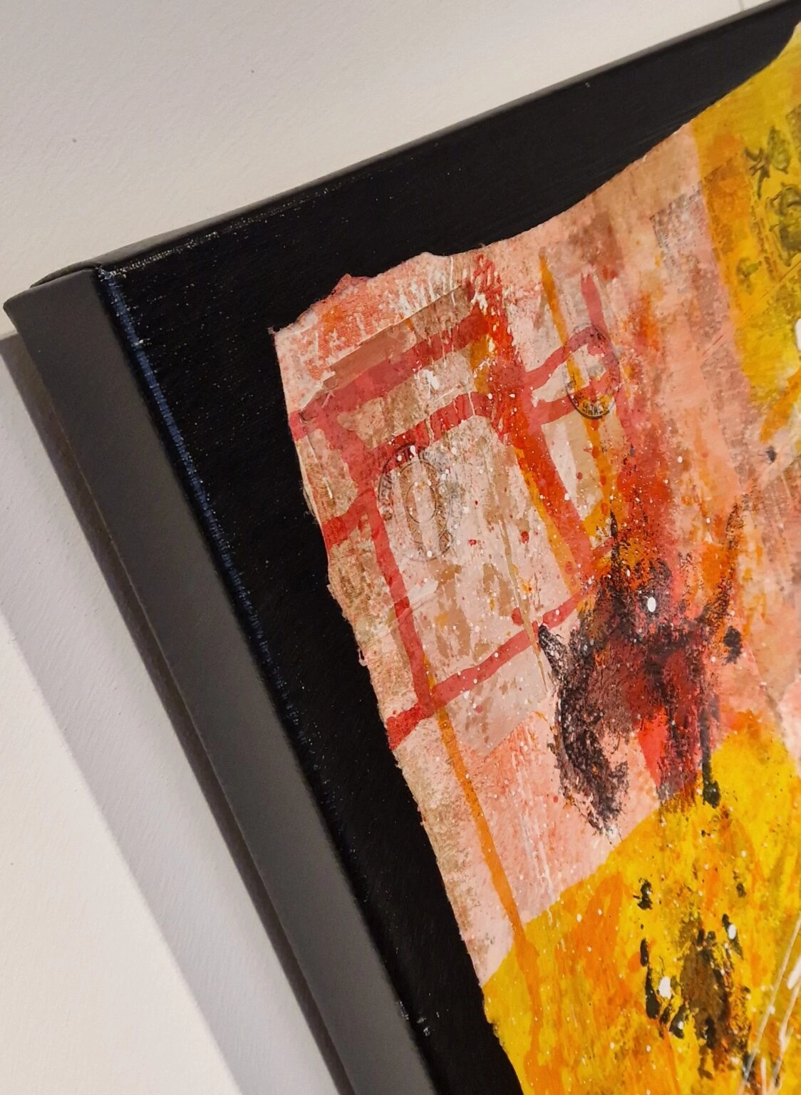 aan de muur wordt een kunstwerk getoond